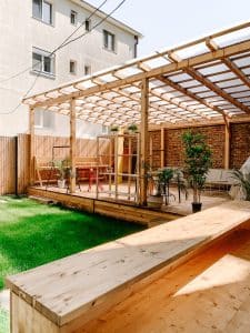 brown wooden fence near green plants during daytime